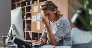 What is the future of wellbeing for SMEs? Stressed casual business woman feeling eye pain