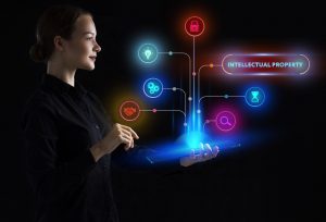 The concept of business, technology, the Internet and the network. A young entrepreneur working on a virtual screen of the future and sees the inscription: Intellectual property