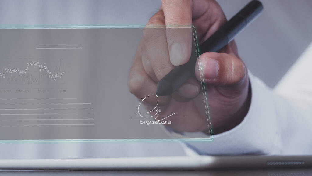 businessman use electronic pen sign signature on electronic E-signing, data sheet document management, paperless office concept. Businessman using stylus pen signing e document on digital tablet.