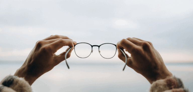 company vision. hands holding glasses to look into the distance
