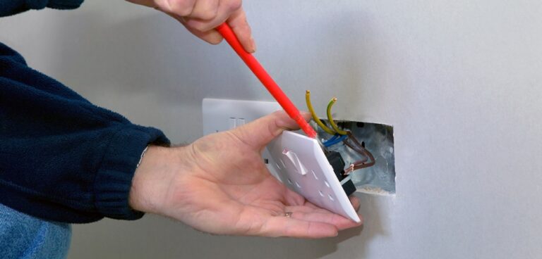 Trades people - electrician rewiring a socket