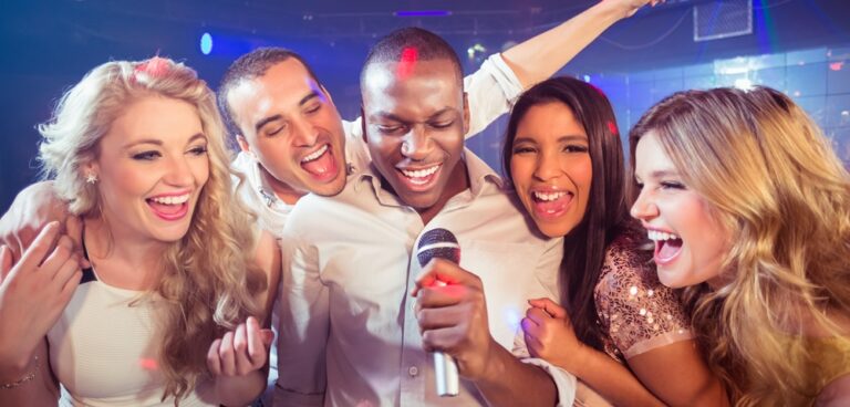 Happy friends singing at the karaoke