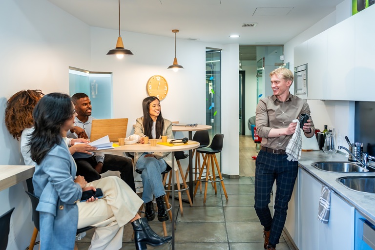 Coworkers chatting and having a coffee