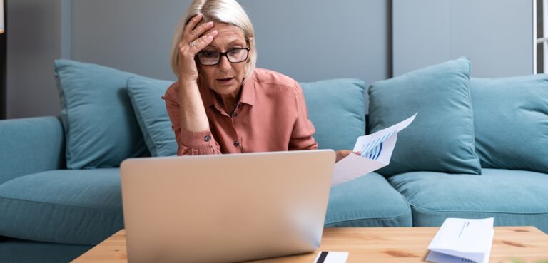senior lady looking shocked at PC